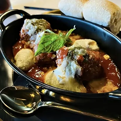 Baked meatballs with whipped ricotta, basil pesto and warm ciabatta